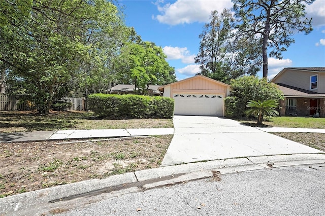 14615 Daybreak Dr, Lutz, FL 33559 - view of property hidden behind natural elements featuring driveway and an attached garage