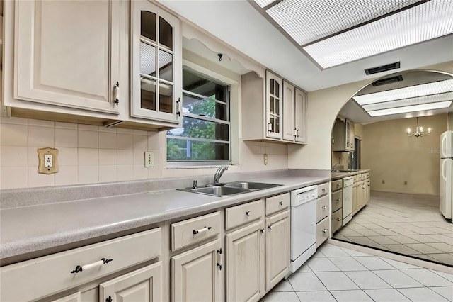 14615 Daybreak Dr, Lutz, FL 33559 - kitchen with white appliances, light tile patterned flooring, glass insert cabinets, a chandelier, and light countertops