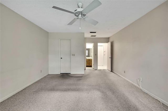14615 Daybreak Dr, Lutz, FL 33559 - unfurnished bedroom with light carpet, ensuite bathroom, a textured ceiling, and a ceiling fan