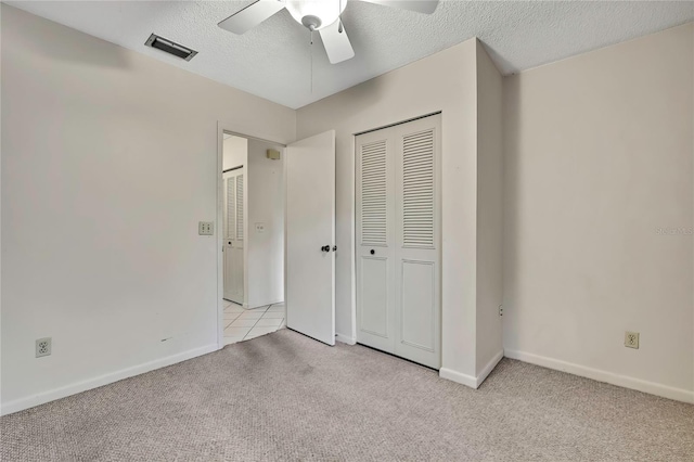 14615 Daybreak Dr, Lutz, FL 33559 - unfurnished bedroom featuring light carpet, a closet, a textured ceiling, and a ceiling fan