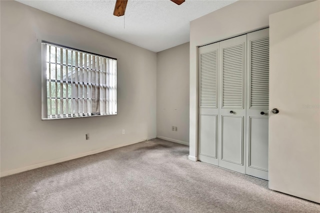 14615 Daybreak Dr, Lutz, FL 33559 - unfurnished bedroom with carpet flooring, a closet, a textured ceiling, and ceiling fan
