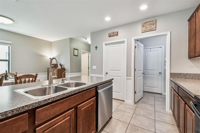 10148 Rose Petal Pl, Riverview, FL 33578 - kitchen with stainless steel dishwasher, dark countertops, recessed lighting, a sink, and light tile patterned floors