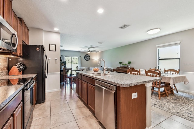 10148 Rose Petal Pl, Riverview, FL 33578 - kitchen featuring visible vents, a kitchen island with sink, ceiling fan, a sink, and stainless steel appliances