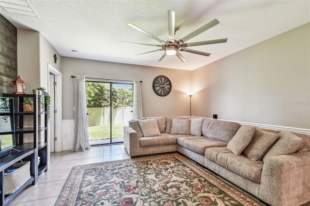10148 Rose Petal Pl, Riverview, FL 33578 - living area featuring visible vents, a ceiling fan, a textured ceiling, and light tile patterned flooring
