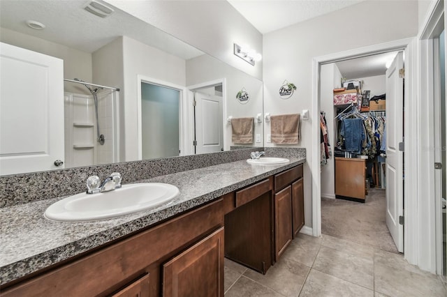 10148 Rose Petal Pl, Riverview, FL 33578 - bathroom with double vanity, a spacious closet, a sink, and a stall shower