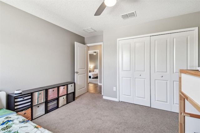 10148 Rose Petal Pl, Riverview, FL 33578 - bedroom with a ceiling fan, a textured ceiling, visible vents, carpet floors, and a closet