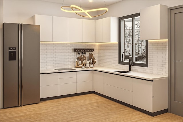 0 9th St, Sarasota, FL 34237 - kitchen with stainless steel fridge, light countertops, backsplash, and a sink