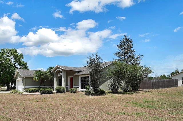 37437 Laurel Hammock Dr, Zephyrhills, FL 33541 - view of front of property featuring a garage, fence, a front yard, and stucco siding