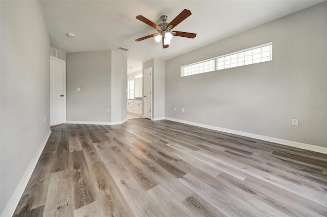37437 Laurel Hammock Dr, Zephyrhills, FL 33541 - unfurnished room with baseboards, ceiling fan, visible vents, and wood finished floors