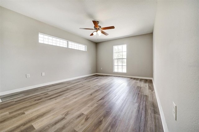 37437 Laurel Hammock Dr, Zephyrhills, FL 33541 - empty room featuring baseboards, ceiling fan, and wood finished floors