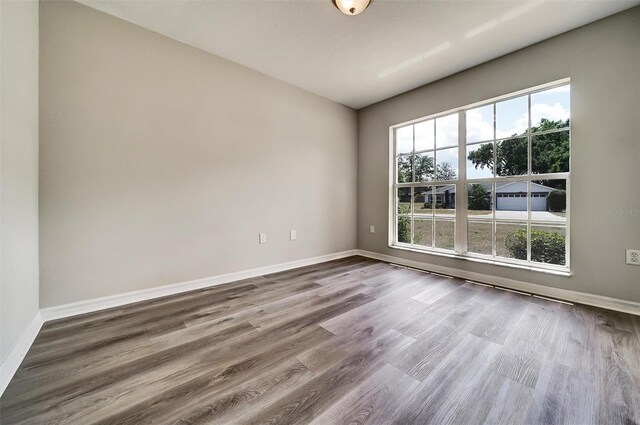 37437 Laurel Hammock Dr, Zephyrhills, FL 33541 - empty room with baseboards and wood finished floors