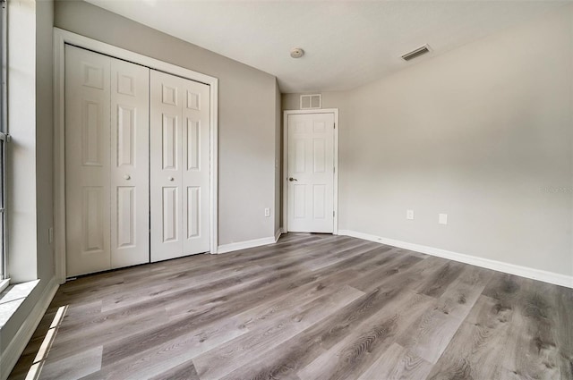 37437 Laurel Hammock Dr, Zephyrhills, FL 33541 - unfurnished bedroom with visible vents, baseboards, wood finished floors, and a closet