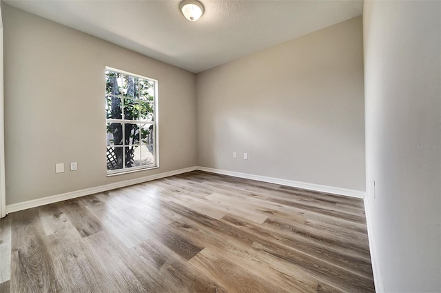 37437 Laurel Hammock Dr, Zephyrhills, FL 33541 - empty room featuring baseboards and wood finished floors