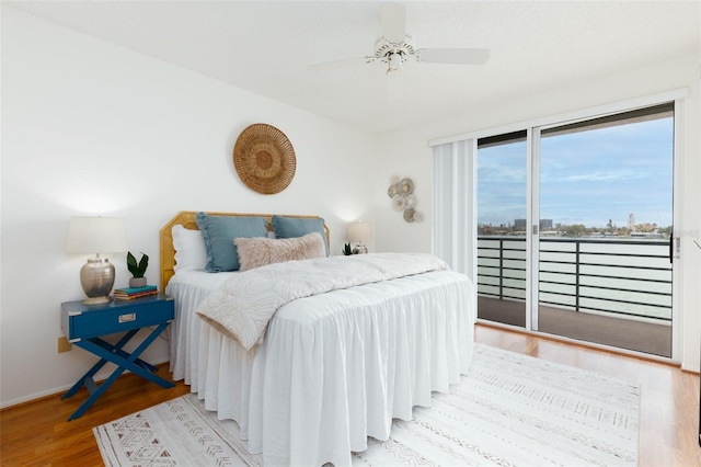bedroom with baseboards, wood finished floors, ceiling fan, and access to exterior
