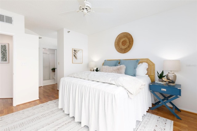 bedroom with ceiling fan, baseboards, visible vents, and wood finished floors