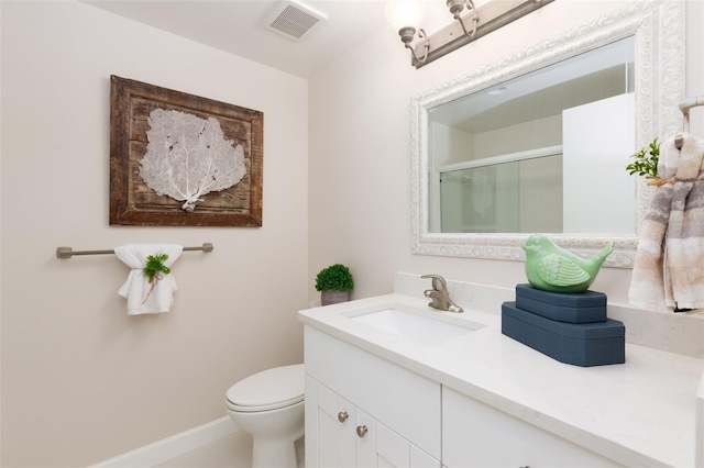 full bath featuring toilet, visible vents, baseboards, a shower stall, and vanity
