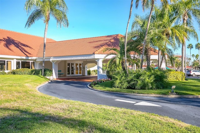 view of property with a carport and driveway