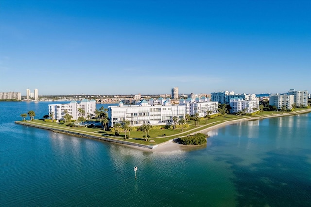 birds eye view of property featuring a city view and a water view
