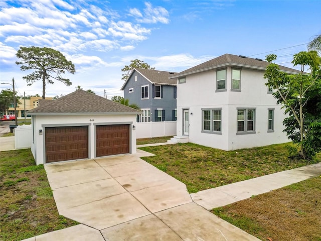 traditional home with fence, stucco siding, and a front yard