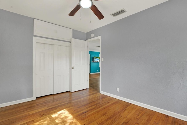 unfurnished bedroom featuring baseboards, light wood-type flooring, and visible vents