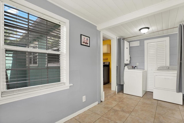 laundry area with independent washer and dryer, wood ceiling, light tile patterned floors, and cabinet space