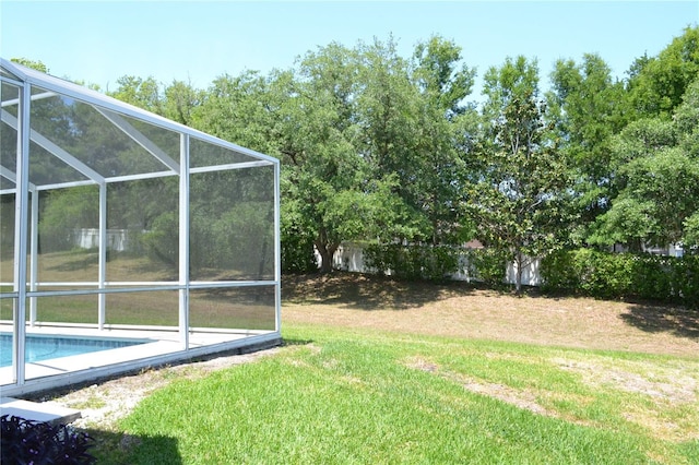 view of yard with glass enclosure and an outdoor pool