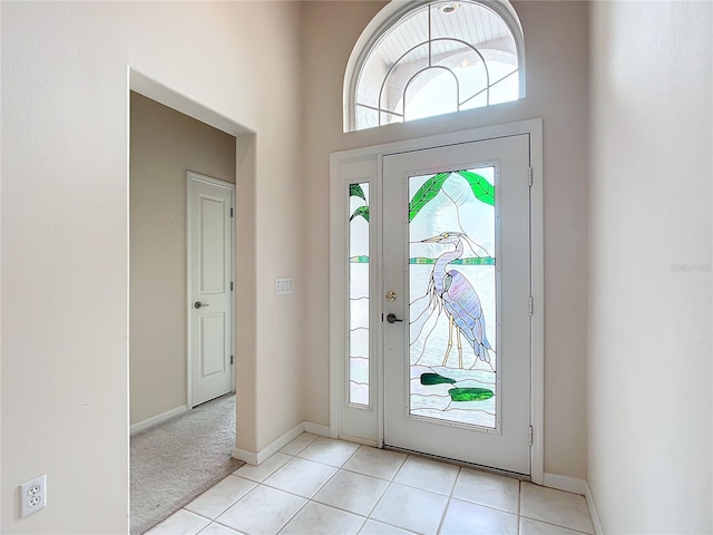 foyer entrance featuring baseboards and light tile patterned flooring