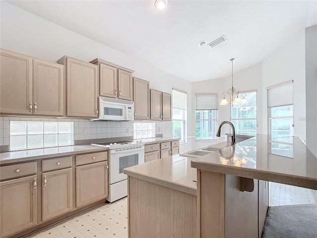 kitchen featuring decorative backsplash, lofted ceiling, white appliances, light floors, and a sink