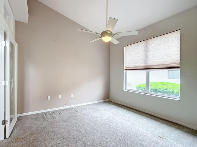 empty room featuring carpet floors, baseboards, and ceiling fan