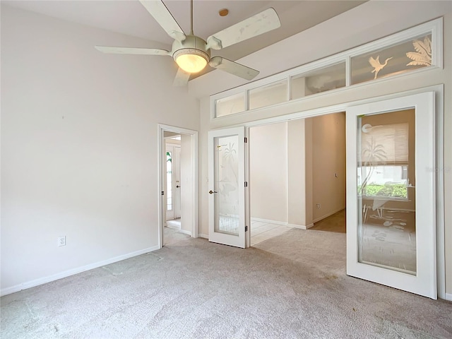 unfurnished bedroom with baseboards, ceiling fan, and carpet