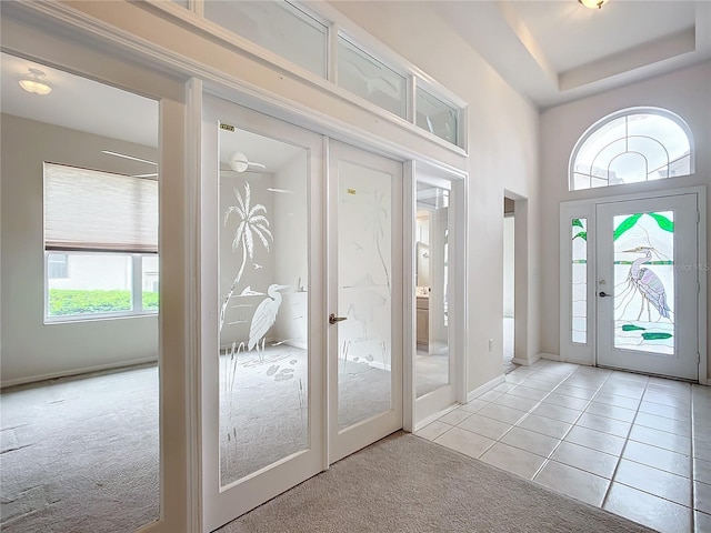 foyer with french doors, light carpet, and a wealth of natural light