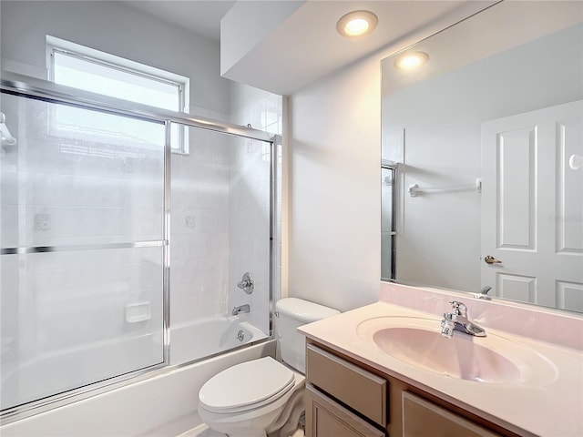 full bath featuring vanity, bath / shower combo with glass door, and toilet