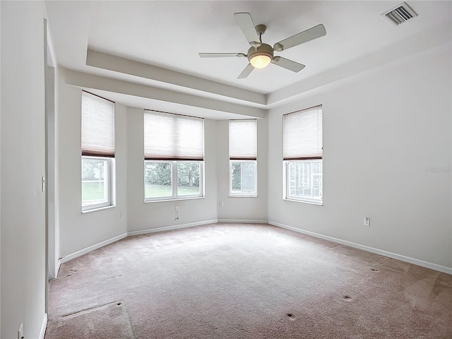 unfurnished room with visible vents, a ceiling fan, baseboards, and carpet floors