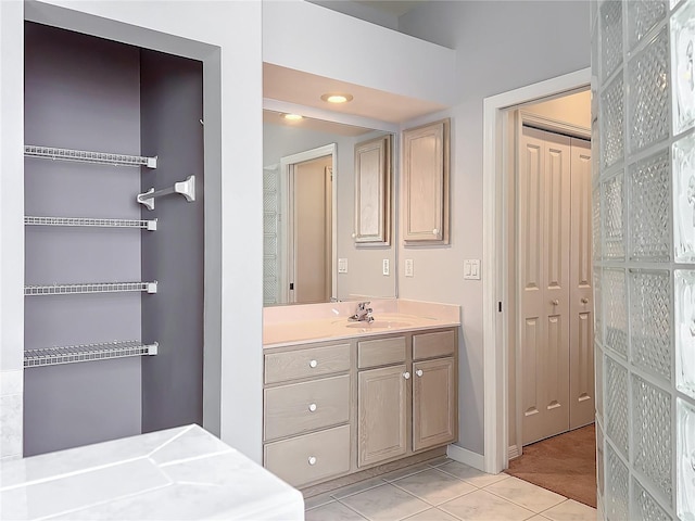 bathroom featuring recessed lighting, tile patterned floors, baseboards, and vanity