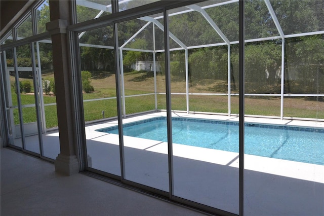 outdoor pool with a patio area and a lanai