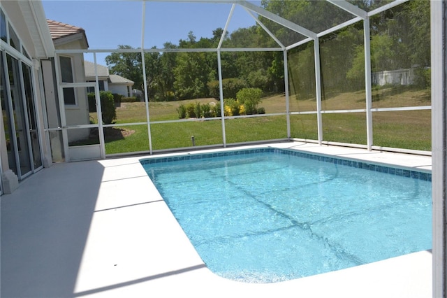 pool featuring a lawn, a lanai, and a patio