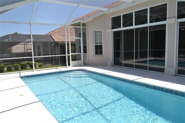 pool featuring a lanai and a patio area