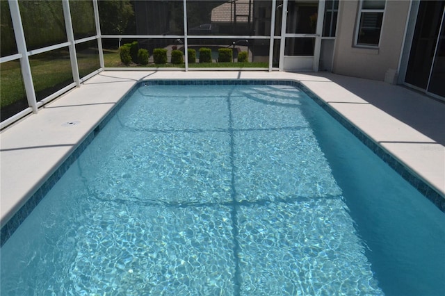 pool with a lanai and a patio area