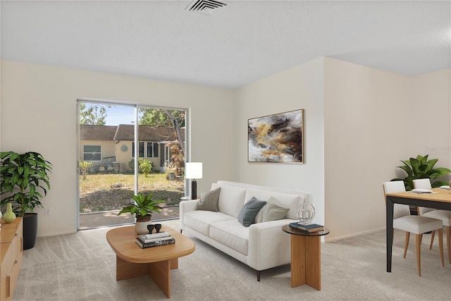 living room featuring visible vents and light colored carpet