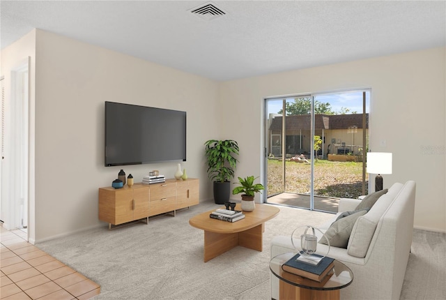 living area featuring light colored carpet, baseboards, and visible vents