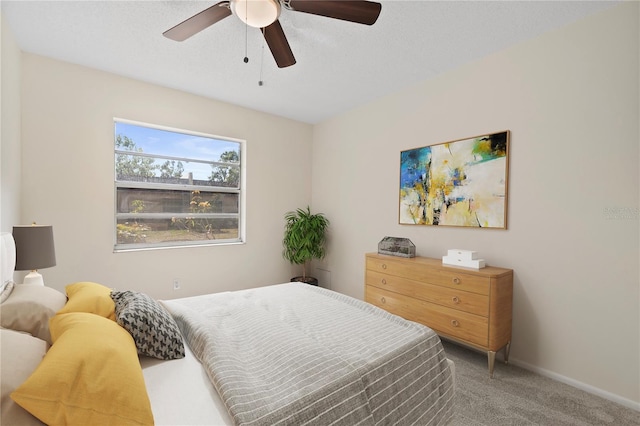 carpeted bedroom with baseboards and a ceiling fan