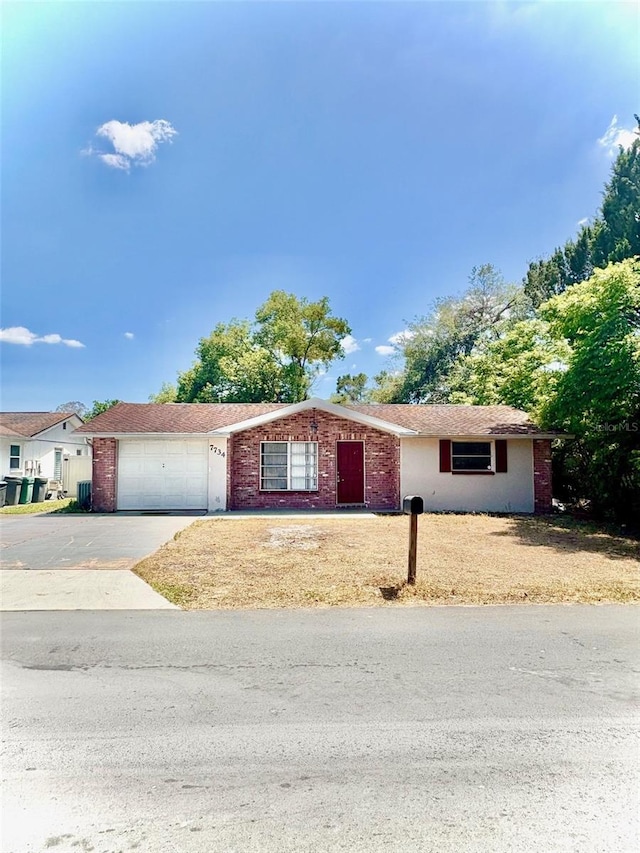 7734 Judith Cres, Port Richey, FL 34668 - single story home featuring a garage, driveway, and brick siding