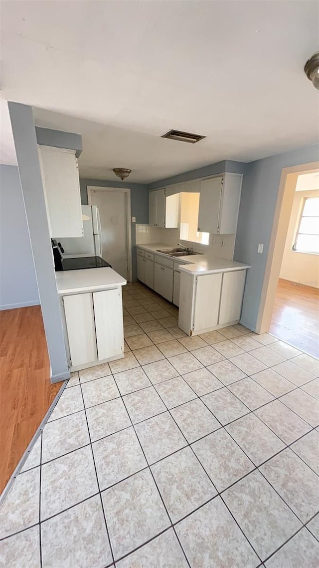 7734 Judith Cres, Port Richey, FL 34668 - kitchen with a sink, light countertops, gray cabinets, and light tile patterned floors