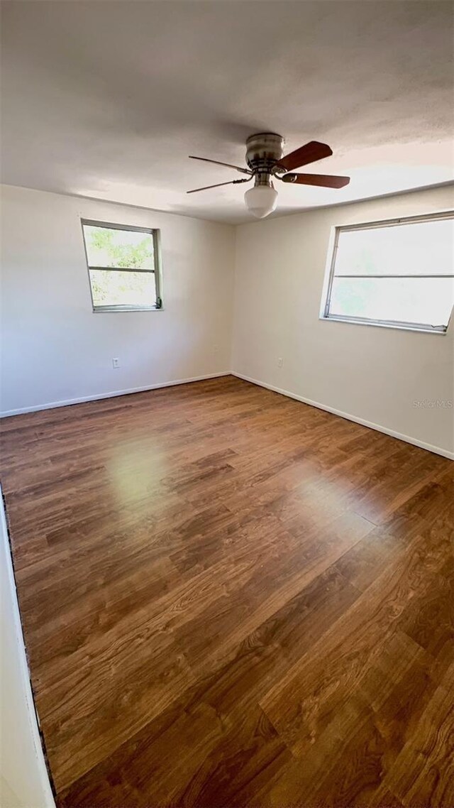 7734 Judith Cres, Port Richey, FL 34668 - empty room featuring baseboards, a ceiling fan, and wood finished floors
