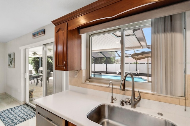 1403 Garden Ave, Tarpon Springs, FL 34689 - kitchen with a sink, light countertops, plenty of natural light, and stainless steel dishwasher