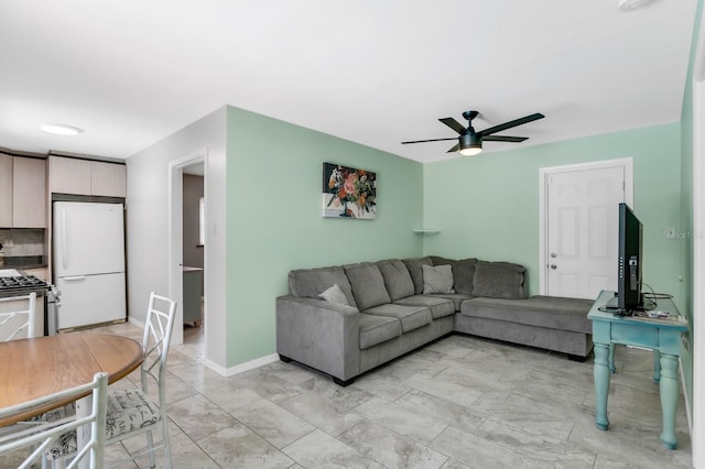 1403 Garden Ave, Tarpon Springs, FL 34689 - living area featuring a ceiling fan, baseboards, and light marble finish flooring