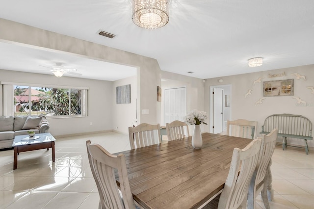 1403 Garden Ave, Tarpon Springs, FL 34689 - dining space featuring light tile patterned flooring, a chandelier, baseboards, and ceiling fan