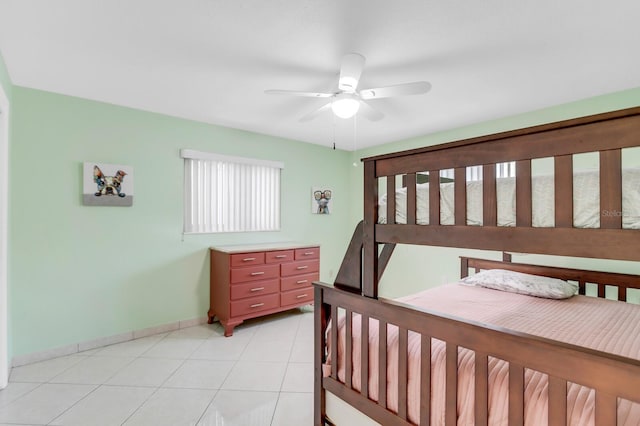 1403 Garden Ave, Tarpon Springs, FL 34689 - bedroom with baseboards, light tile patterned floors, and ceiling fan
