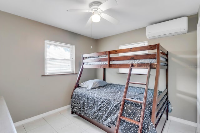 1403 Garden Ave, Tarpon Springs, FL 34689 - bedroom with a wall mounted AC, baseboards, light tile patterned floors, and a ceiling fan