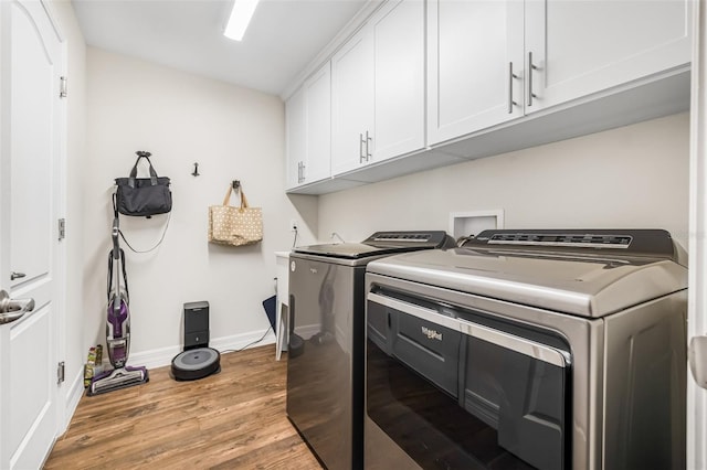 4808 Jackson Club Loop, Tampa, FL 33624 - washroom featuring cabinet space, washing machine and dryer, and light wood-style flooring